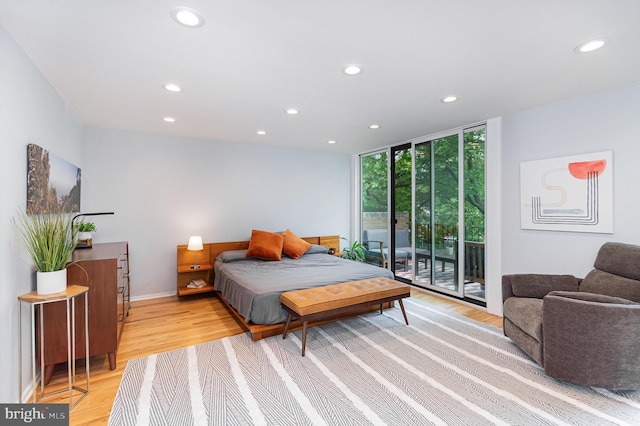 1690 Chimney House Rd, Reston, VA 20190 - bedroom featuring recessed lighting, access to outside, a wall of windows, and light wood-type flooring