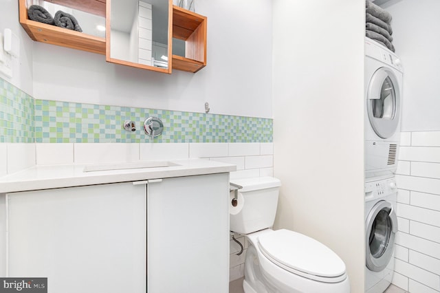 1690 Chimney House Rd, Reston, VA 20190 - bathroom featuring stacked washer and clothes dryer, tile walls, and vanity