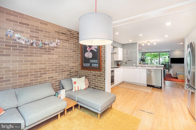 1690 Chimney House Rd, Reston, VA 20190 - kitchen featuring stainless steel appliances, open floor plan, white cabinetry, a peninsula, and light countertops