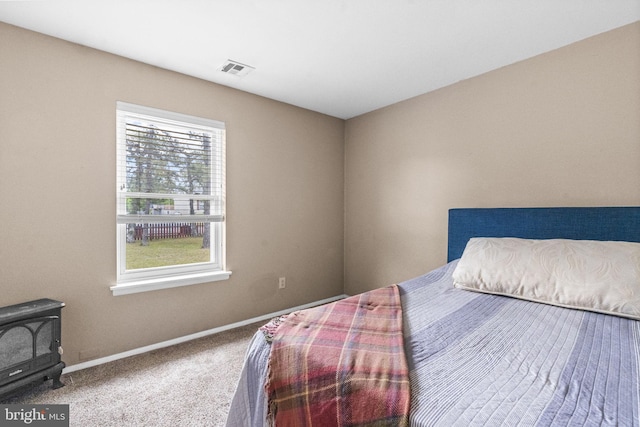 54 Tecumseh Trl, Browns Mills, NJ 08015 - carpeted bedroom featuring baseboards and a wood stove