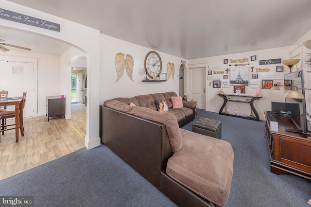 724 S W Ave, Vineland, NJ 08360 - carpeted living room with arched walkways, a ceiling fan, wood finished floors, and baseboards