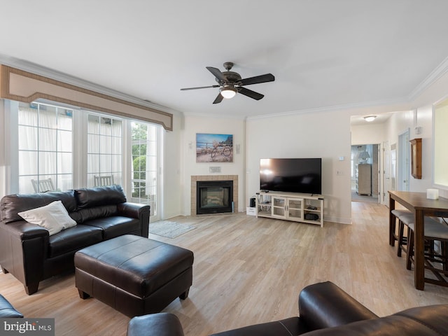 30619 Cedar Neck Rd Unit 1101, Ocean View, DE 19970 - living room featuring light wood-style floors, a ceiling fan, crown molding, a fireplace, and baseboards