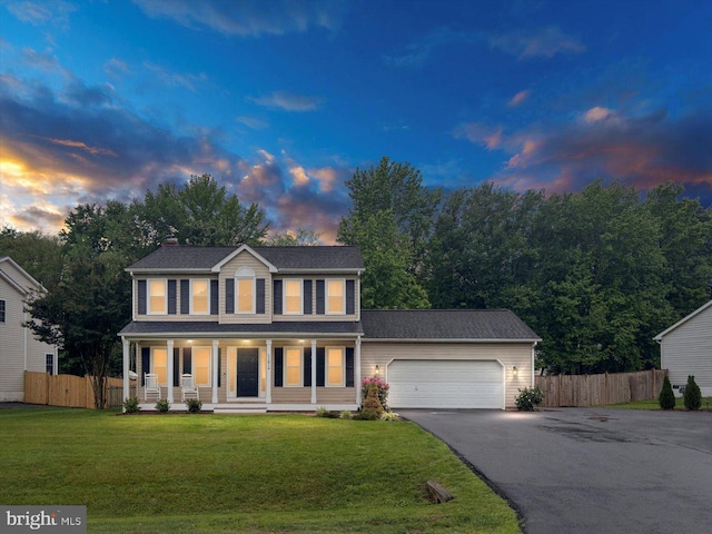 11814 Arbor Glen Dr, Fredericksburg, VA 22407 - colonial-style house with driveway, covered porch, an attached garage, and a chimney