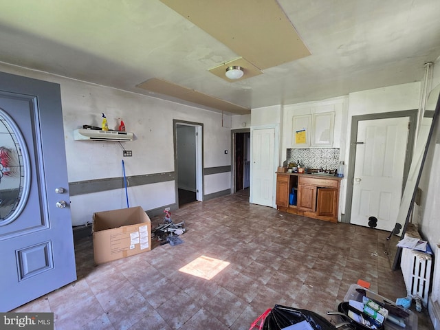 245 Beech St, Pottstown, PA 19464 - kitchen with a sink, dark floors, backsplash, radiator, and white cabinets