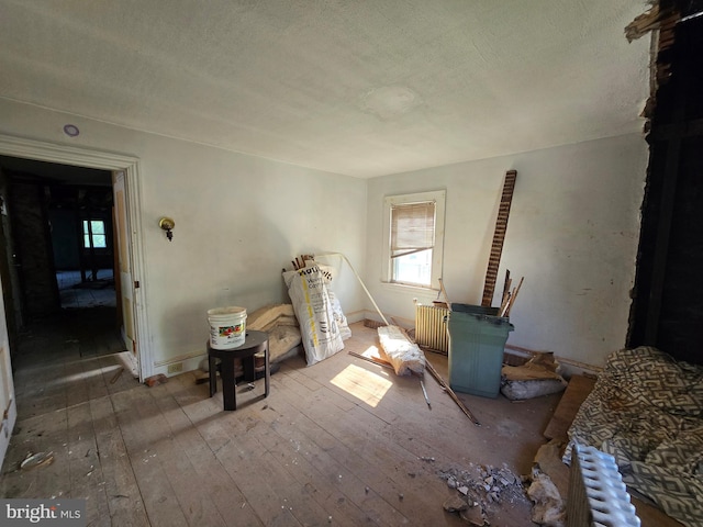 245 Beech St, Pottstown, PA 19464 - living room with hardwood / wood-style floors, radiator, a textured ceiling, and baseboards