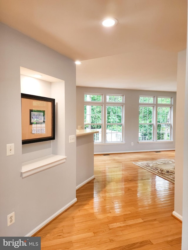 9120 Stonegarden Dr, Lorton, VA 22079 - hall with healthy amount of natural light, wood finished floors, baseboards, and recessed lighting