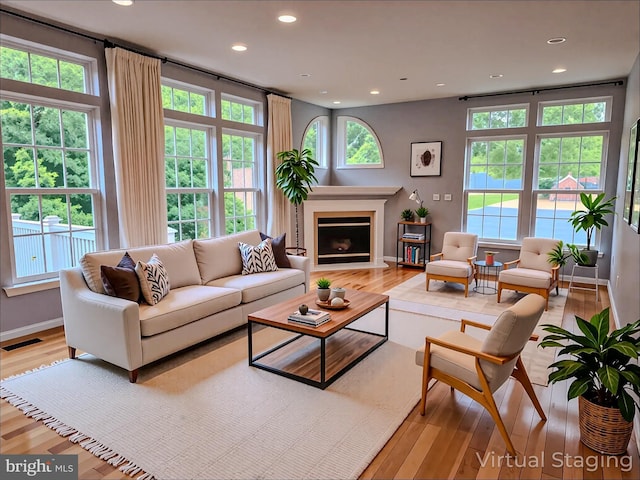 9120 Stonegarden Dr, Lorton, VA 22079 - living area featuring light wood-style floors, recessed lighting, a fireplace with flush hearth, and baseboards