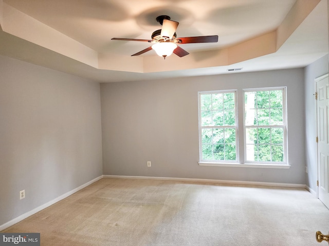 9120 Stonegarden Dr, Lorton, VA 22079 - unfurnished room with light colored carpet, ceiling fan, a tray ceiling, and baseboards