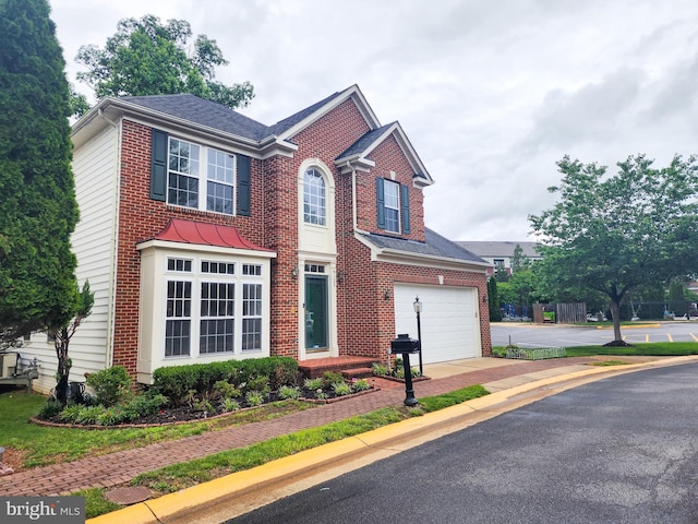 9120 Stonegarden Dr, Lorton, VA 22079 - view of front of home with driveway, brick siding, and an attached garage