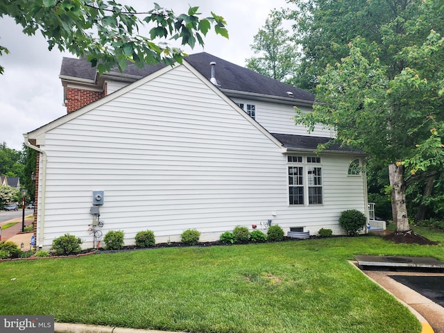 9120 Stonegarden Dr, Lorton, VA 22079 - view of property exterior with a yard and a shingled roof