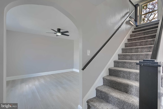 518 Fairview Ave, Baltimore, MD 21224 - stairway with arched walkways, wood finished floors, ceiling fan, and baseboards