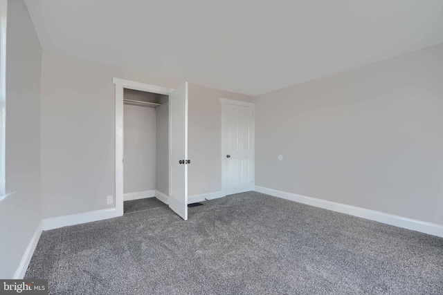518 Fairview Ave, Baltimore, MD 21224 - unfurnished bedroom featuring dark colored carpet, baseboards, and a closet