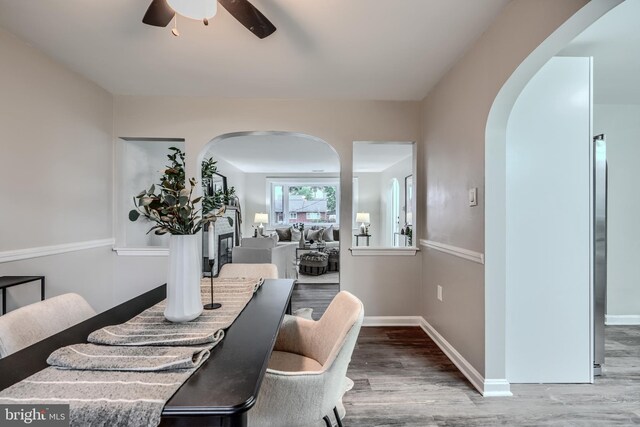 6505 Corkley Rd, Baltimore, MD 21237 - dining room with arched walkways, wood finished floors, and a ceiling fan