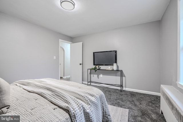 6505 Corkley Rd, Baltimore, MD 21237 - carpeted bedroom with radiator, arched walkways, and baseboards