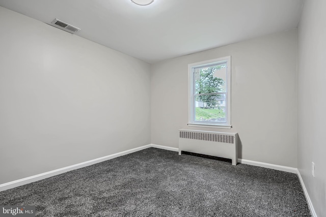 6505 Corkley Rd, Baltimore, MD 21237 - spare room with radiator heating unit, dark carpet, and baseboards