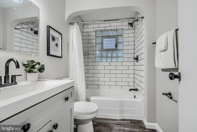 6505 Corkley Rd, Baltimore, MD 21237 - full bathroom featuring vanity, toilet, wood finished floors, and shower / bath combination with curtain