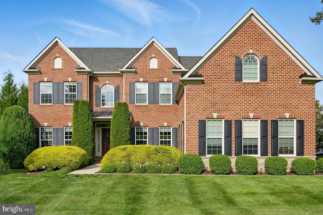 14894 Michele Dr, Glenelg, MD 21737 - colonial-style house featuring brick siding, a front yard, and a shingled roof
