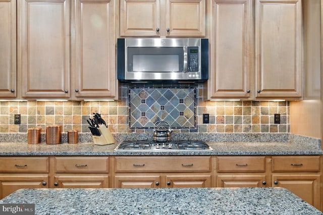 14894 Michele Dr, Glenelg, MD 21737 - kitchen featuring stainless steel appliances, tasteful backsplash, and light stone countertops