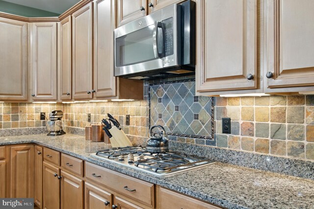 14894 Michele Dr, Glenelg, MD 21737 - kitchen featuring appliances with stainless steel finishes, tasteful backsplash, and light stone counters