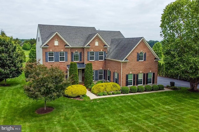 14894 Michele Dr, Glenelg, MD 21737 - colonial house featuring brick siding, a front yard, and a shingled roof
