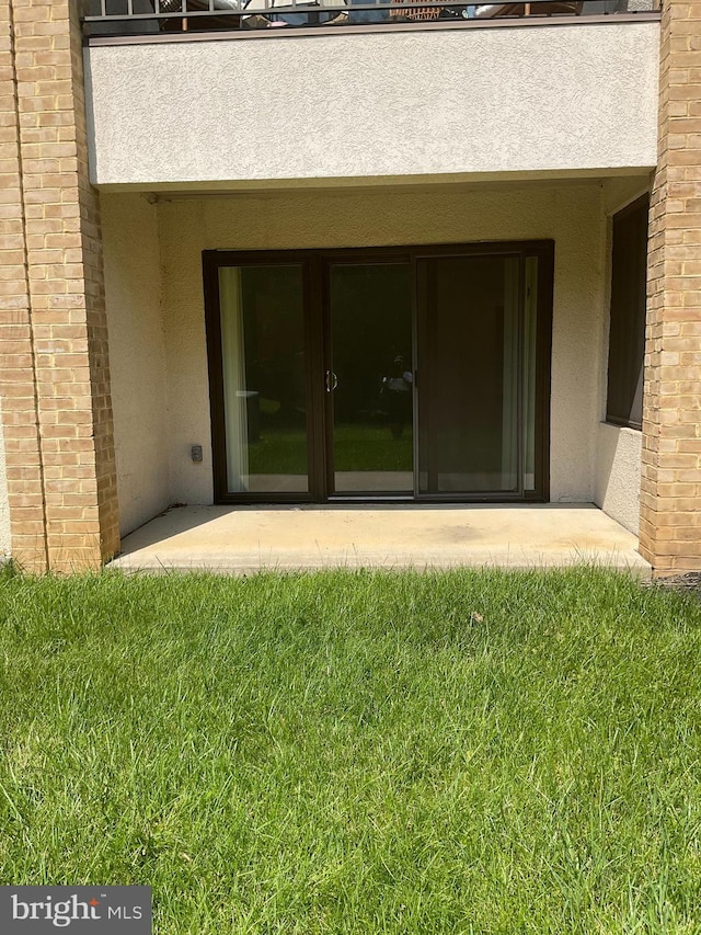 1002 Brinker Dr Unit 101, Hagerstown, MD 21740 - property entrance featuring stucco siding, a lawn, and a patio
