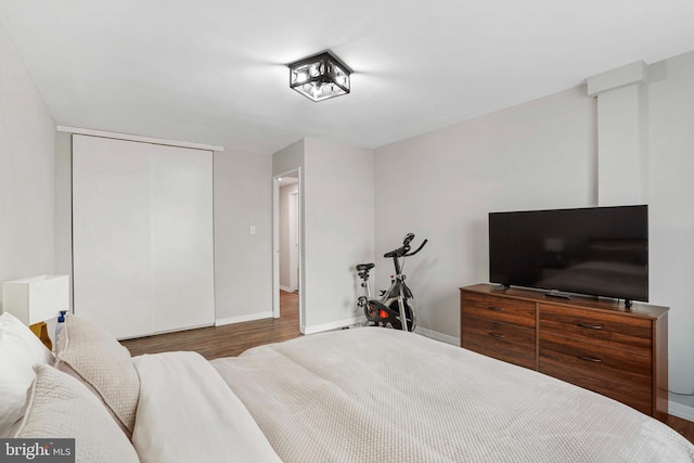 1200 S Arlington Ridge Rd Unit 314, Arlington, VA 22202 - bedroom featuring wood finished floors, baseboards, and a closet