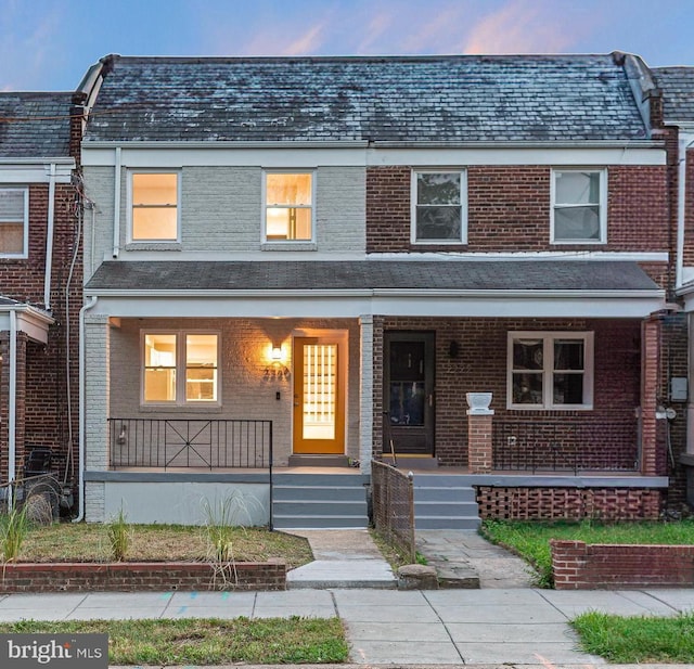 2220 13th St NE, Washington, DC 20018 - view of property featuring covered porch, brick siding, and a high end roof