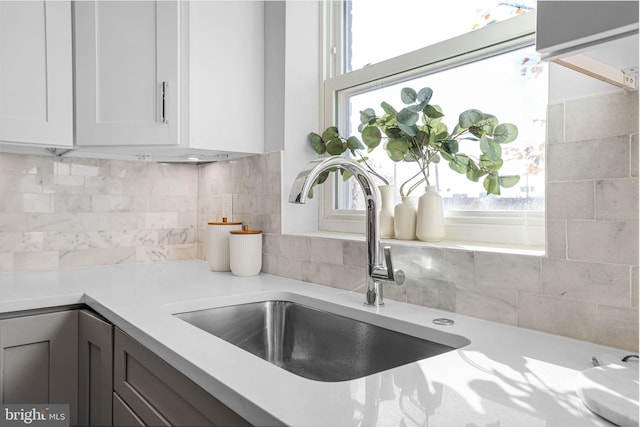 2220 13th St NE, Washington, DC 20018 - kitchen with a sink, backsplash, light countertops, and white cabinetry