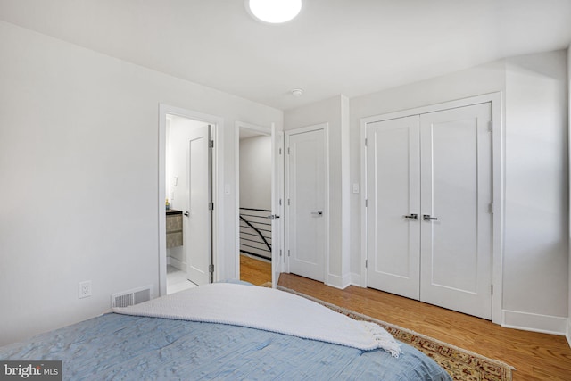 2220 13th St NE, Washington, DC 20018 - bedroom featuring wood finished floors, baseboards, and connected bathroom