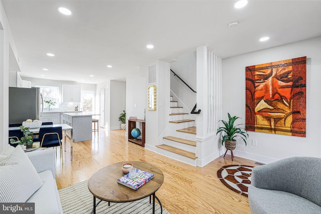 2220 13th St NE, Washington, DC 20018 - living area featuring stairs, recessed lighting, light wood-style floors, and baseboards
