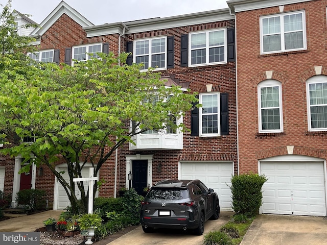 8245 Singleleaf Ln, Lorton, VA 22079 - townhome / multi-family property with brick siding, driveway, and an attached garage