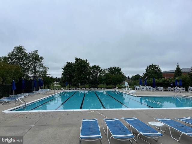 8245 Singleleaf Ln, Lorton, VA 22079 - community pool featuring a patio