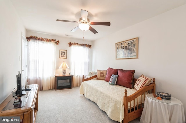 44 Heals Farm Rd, Burlington, NJ 08016 - carpeted bedroom with a ceiling fan and a glass covered fireplace