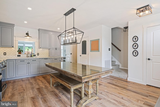 1343 Arabis Ct, Belcamp, MD 21017 - kitchen with gray cabinets, light wood-type flooring, decorative backsplash, light countertops, and recessed lighting
