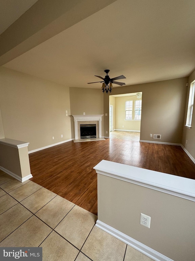6 Sickler Ct, Sewell, NJ 08080 - unfurnished living room with ceiling fan, wood finished floors, healthy amount of natural light, and a fireplace with flush hearth