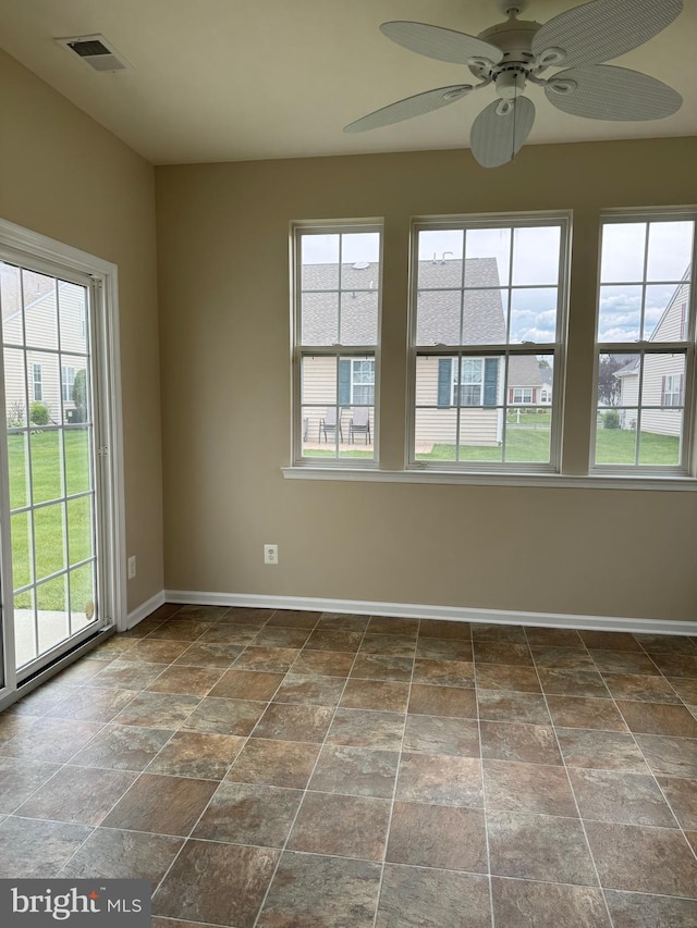 6 Sickler Ct, Sewell, NJ 08080 - spare room featuring plenty of natural light, baseboards, ceiling fan, and dark stone finish floors