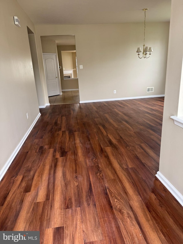 6 Sickler Ct, Sewell, NJ 08080 - unfurnished room featuring a chandelier, baseboards, and dark wood-style floors
