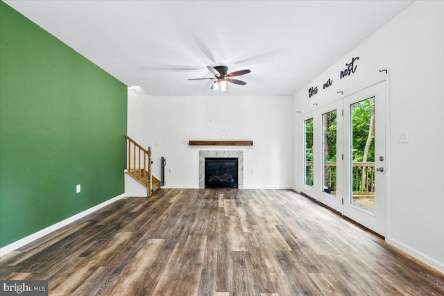 163 Hyde Park Ln, Charles Town, WV 25414 - unfurnished living room featuring wood finished floors, stairway, baseboards, and a glass covered fireplace