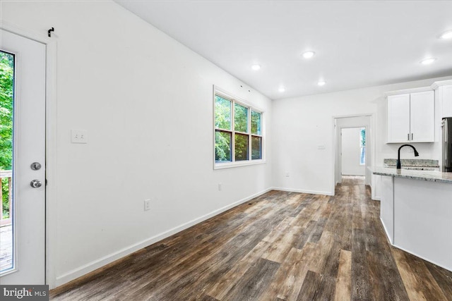 163 Hyde Park Ln, Charles Town, WV 25414 - unfurnished living room with dark wood finished floors, a sink, baseboards, and recessed lighting