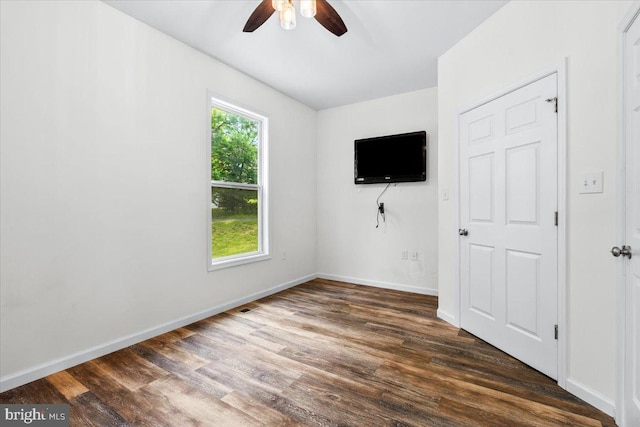 163 Hyde Park Ln, Charles Town, WV 25414 - unfurnished bedroom featuring multiple windows, dark wood-type flooring, baseboards, and ceiling fan