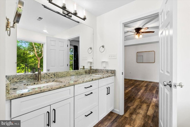 163 Hyde Park Ln, Charles Town, WV 25414 - full bathroom with double vanity, wood finished floors, ceiling fan, and baseboards