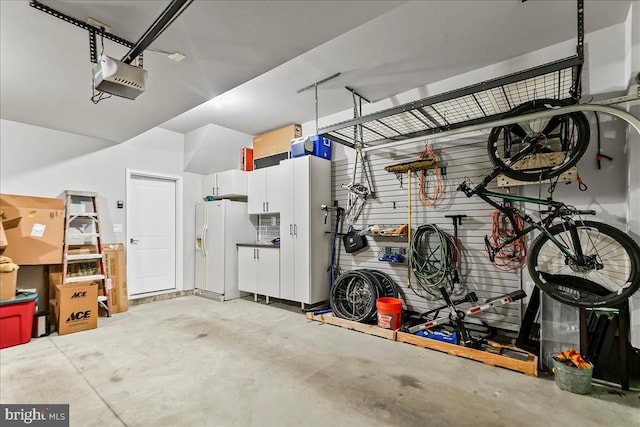 368 Star Tavern Ln, West Chester, PA 19382 - garage featuring white refrigerator with ice dispenser and a garage door opener