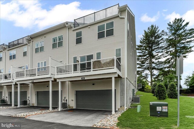 368 Star Tavern Ln, West Chester, PA 19382 - back of property with a garage, driveway, a lawn, and cooling unit