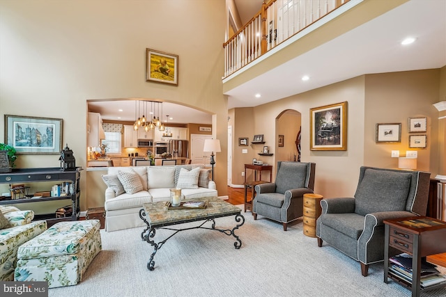 18403 Rim Rock Cir, Leesburg, VA 20176 - living room with arched walkways, a towering ceiling, recessed lighting, and a chandelier