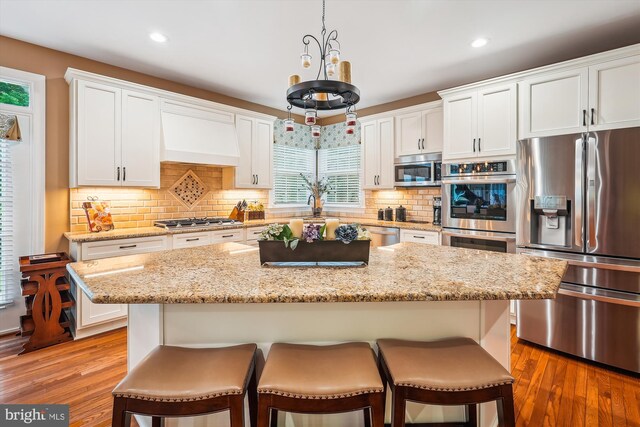 18403 Rim Rock Cir, Leesburg, VA 20176 - kitchen featuring appliances with stainless steel finishes, a kitchen bar, white cabinets, and recessed lighting