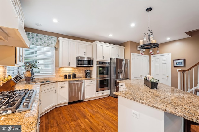 18403 Rim Rock Cir, Leesburg, VA 20176 - kitchen featuring stainless steel appliances, wood finished floors, tasteful backsplash, under cabinet range hood, and recessed lighting