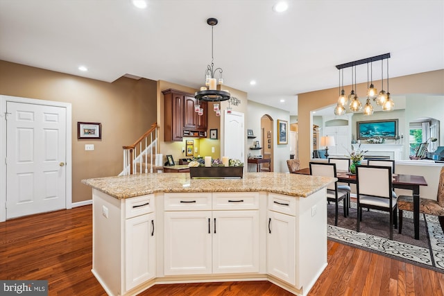 18403 Rim Rock Cir, Leesburg, VA 20176 - kitchen with a chandelier, arched walkways, dark wood finished floors, a kitchen island, and recessed lighting