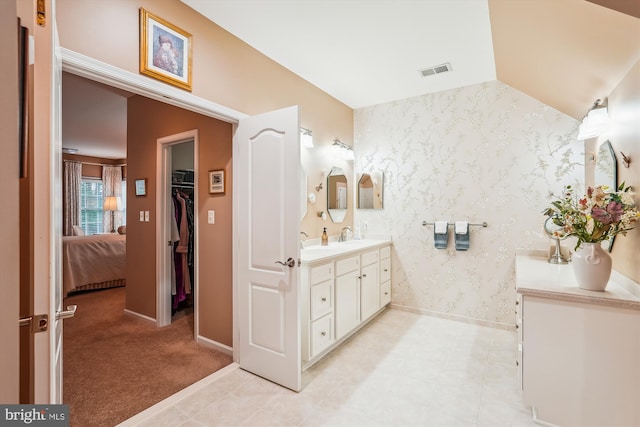 18403 Rim Rock Cir, Leesburg, VA 20176 - ensuite bathroom with vanity, wallpapered walls, baseboards, and a spacious closet