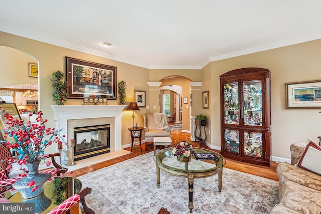 18403 Rim Rock Cir, Leesburg, VA 20176 - living room with arched walkways, ornamental molding, wood finished floors, baseboards, and a fireplace