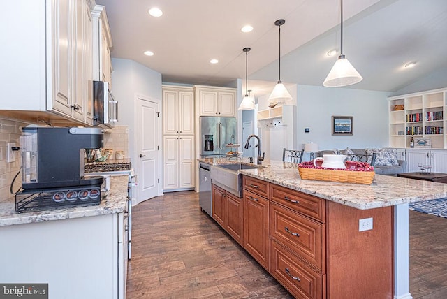 24440 Harvest Cir, Milton, DE 19968 - kitchen featuring appliances with stainless steel finishes, a sink, dark wood-style flooring, light stone counters, and tasteful backsplash